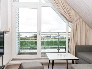 a living room with a large window and a table at 6 person holiday home in Wendtorf in Wendtorf