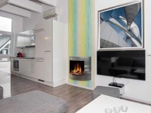 a living room with a fireplace and a tv at 6 person holiday home in Wendtorf in Wendtorf