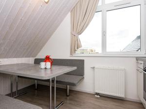 a table and a chair in a room with a window at 6 person holiday home in Wendtorf in Wendtorf