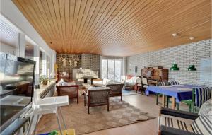 a living room with a table and chairs at Pet Friendly Home In Thisted With Kitchen in Thisted