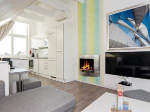 a living room with a fireplace in the wall at Holiday Home Strandblick VII in Wendtorf