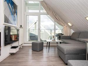 a living room with a couch and a table at Holiday Home Strandblick VII in Wendtorf