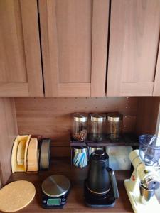 a kitchen counter with a coffee maker on a shelf at GuestHouse YADOYA - Vacation STAY 08450v in Tokamachi