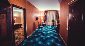 a hotel room with a hallway with a blue carpet at Afonya Inn in Nizhny Novgorod