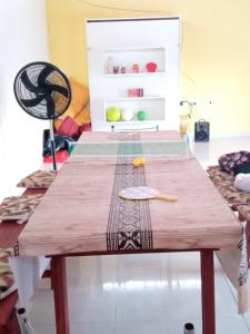 a wooden table in a room with a refrigerator at Espacio LORENZO in Arana