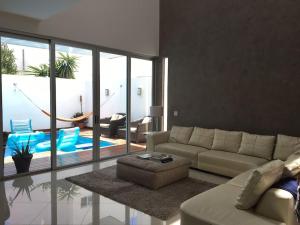 a living room with a couch and a living room with at Spacious Luxury Home in Cancún