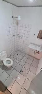 a bathroom with a toilet and a sink at Hostel Praia 102 in Ubatuba