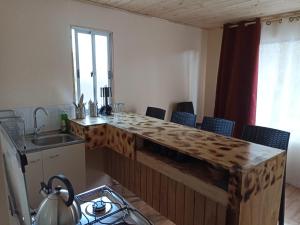 a kitchen with a wooden counter top in a room at El Fogon de Rio Claro in Rio Claro