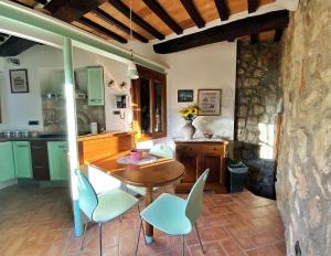 a kitchen with a wooden table and chairs at Casa Armandina - Tuscan ToBe in Santa Fiora