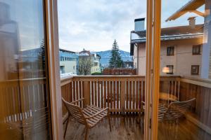 a balcony with chairs and a view of a building at NOAS Home in Innsbruck