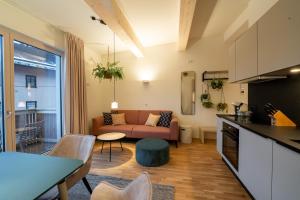 a kitchen and living room with a couch and a table at NOAS Home in Innsbruck