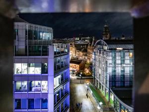 a view of a city at night with buildings at View of the City - Fantastic, Spacious 2 Bed Apartment, Netflix, Stunning Views, Sheffield City Centre in Sheffield