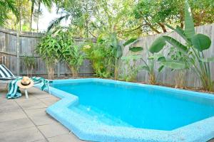 a swimming pool in a backyard with a fence at Casa Katharina – Your Coastal Escape on Noosa Hill in Noosa Heads