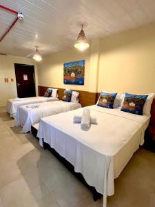 a room with two beds in a room at Arena Carneiros Hotel by AFT in Tamandaré