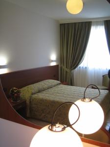 מיטה או מיטות בחדר ב-Hotel Sanremo