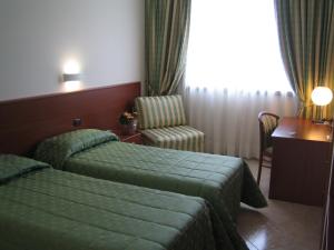 Tempat tidur dalam kamar di Hotel Sanremo