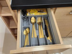 a drawer filled with utensils in a kitchen at Menelaou Cozy Apartment in Athens