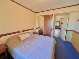 a bedroom with a large bed with a blue floor at Viejo lobo 203 in Ushuaia