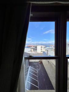 a window view of the beach from a room at Viejo lobo 203 in Ushuaia