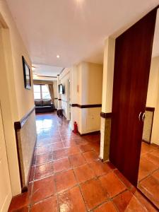 a hallway with a tile floor and a door at Viejo lobo 203 in Ushuaia +6 photos