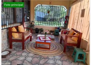 a living room with two chairs and a table at OASIS in Leticia