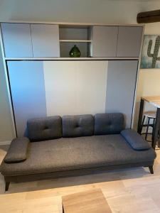 a couch sitting in a living room with a table at Cambrai:studio style loft in Cambrai