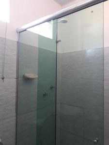a shower with a glass door in a bathroom at Pousada Luar de Alter in Alter do Chao