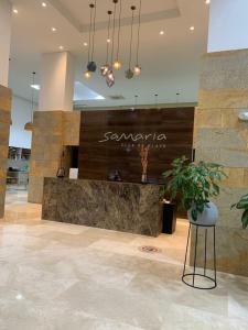 a lobby with a counter in the middle of a building at Best Luxury Samaria in Santa Marta