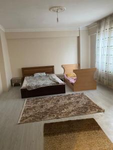 a bedroom with two beds and a table at Sefam konaklama in Erzurum