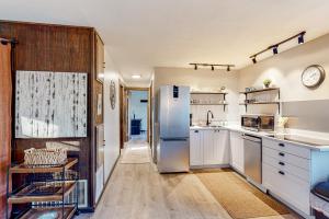 eine Küche mit weißen Schränken und einem Kühlschrank aus Edelstahl in der Unterkunft Vermont Meadow House in West Rutland
