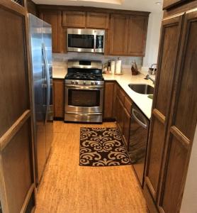 a kitchen with stainless steel appliances and a rug on the floor at RedAwning Highway 189 2 - V044 in Lake Arrowhead