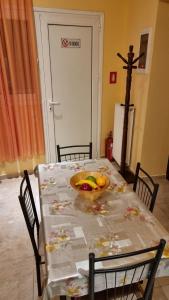 a dining room table with a bowl of fruit on it at Nice Holiday House in Piraeus