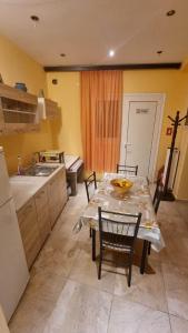 a kitchen with a table and chairs and a sink at Nice Holiday House in Piraeus