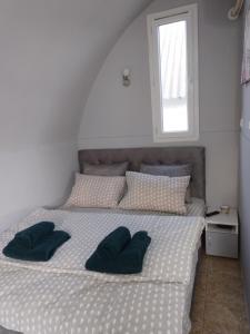 a bedroom with a bed with two pillows on it at Yellow story in Vrdnik