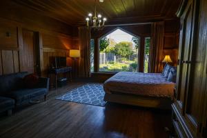 a bedroom with a bed and a large window at The Captains Quarters in Fort Bragg