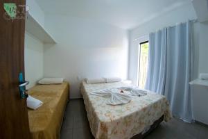 Una cama o camas en una habitación de Vila dos Coqueiros