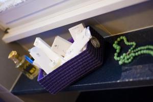 a purple container with a watch on a counter at Domus Fontis in Rome