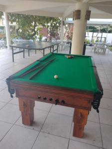a pool table with a ball on top of it at Pousada Aldeia Mar in Ilhéus