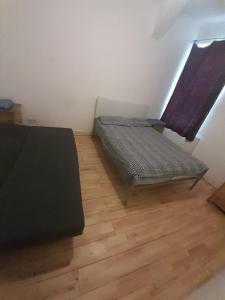 a room with two beds and a wooden floor at Haringey Victorian House in London