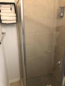 a shower stall with a glass door with towels at A Smaller Piece of Heaven, Near by Lackland AFB in San Antonio