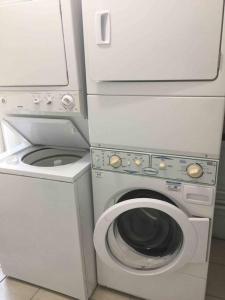a washing machine and a washer in a room at A Smaller Piece of Heaven, Near by Lackland AFB in San Antonio