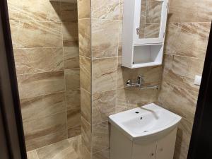 a bathroom with a toilet and a sink at Apartmány Foresta Jasná in Belá