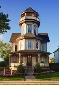 an old house with a tower on top of it at The Tower Cottage Bed and Breakfast in Point Pleasant Beach