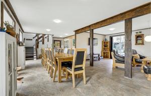 a dining room with a table and chairs at 6 Bedroom Cozy Home In Gudhjem in Gudhjem