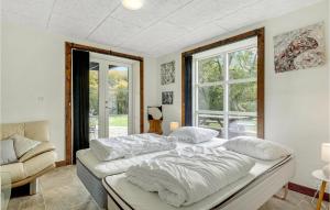 a bedroom with a bed and a couch and a window at 6 Bedroom Cozy Home In Gudhjem in Gudhjem +22 photos