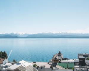a view of a large body of water with mountains at Tangoinn Hostel Downtown in San Carlos de Bariloche