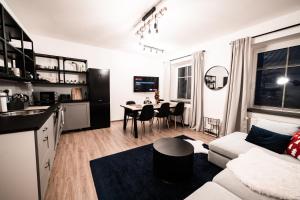 a living room with a couch and a table at Apartment Na Skále CLOSE TO CITY CENTER & SKI LIFT in Špindlerův Mlýn