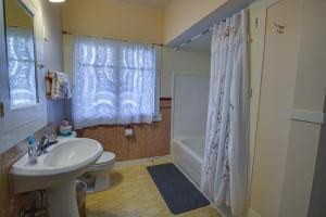 a bathroom with a sink and a toilet and a shower at The Captains Quarters in Fort Bragg