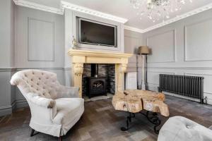 a living room with a fireplace with a tv above it at City Centre Georgian Townhouse in Liverpool