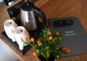 a counter with a coffee maker and a plant on it at Park Head Hotel in Bishop Auckland